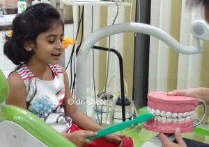 dr shirol10 Dr Dayanand teaching brushing technique to child
